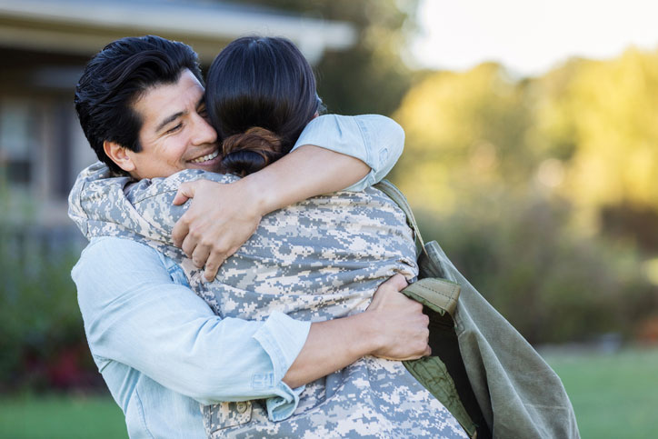 husband hugging his military wife