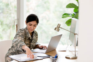 female in military dress working on homework